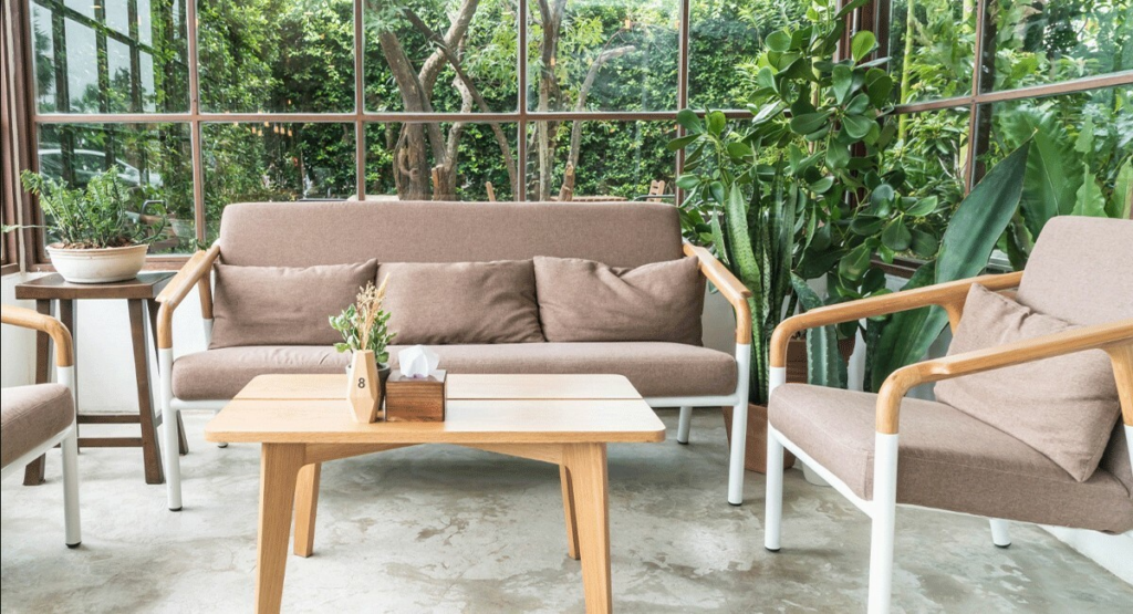outdoor coffee table seating with a wooden table and greenery around