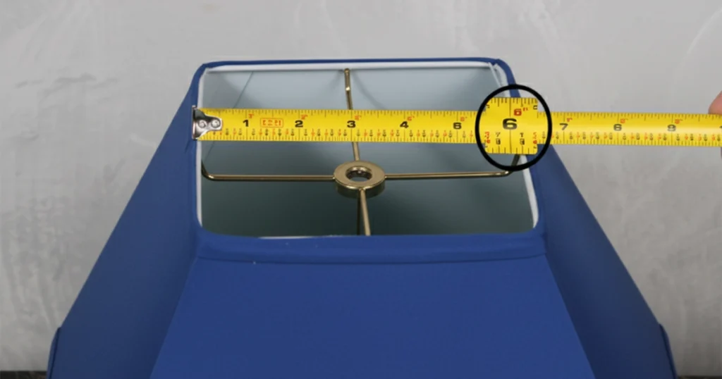 Tape measure across top width of lampshade on stand