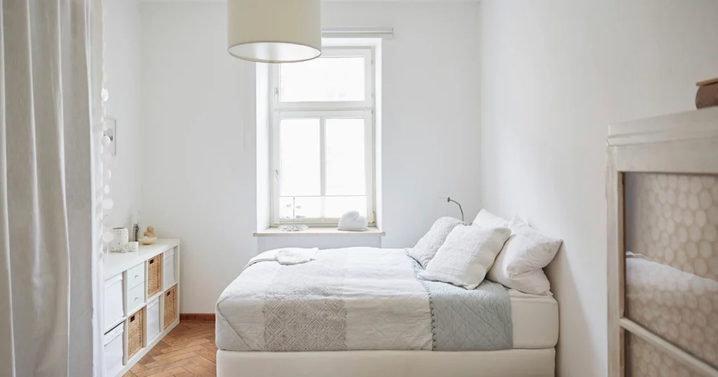 Bright small bedroom with minimalist decor and furniture